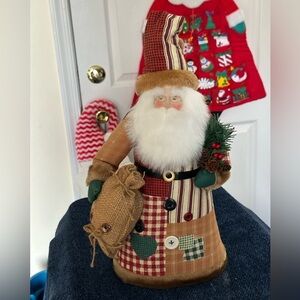 Santa tree topper in shades of browns & reds. Made of fabric.
